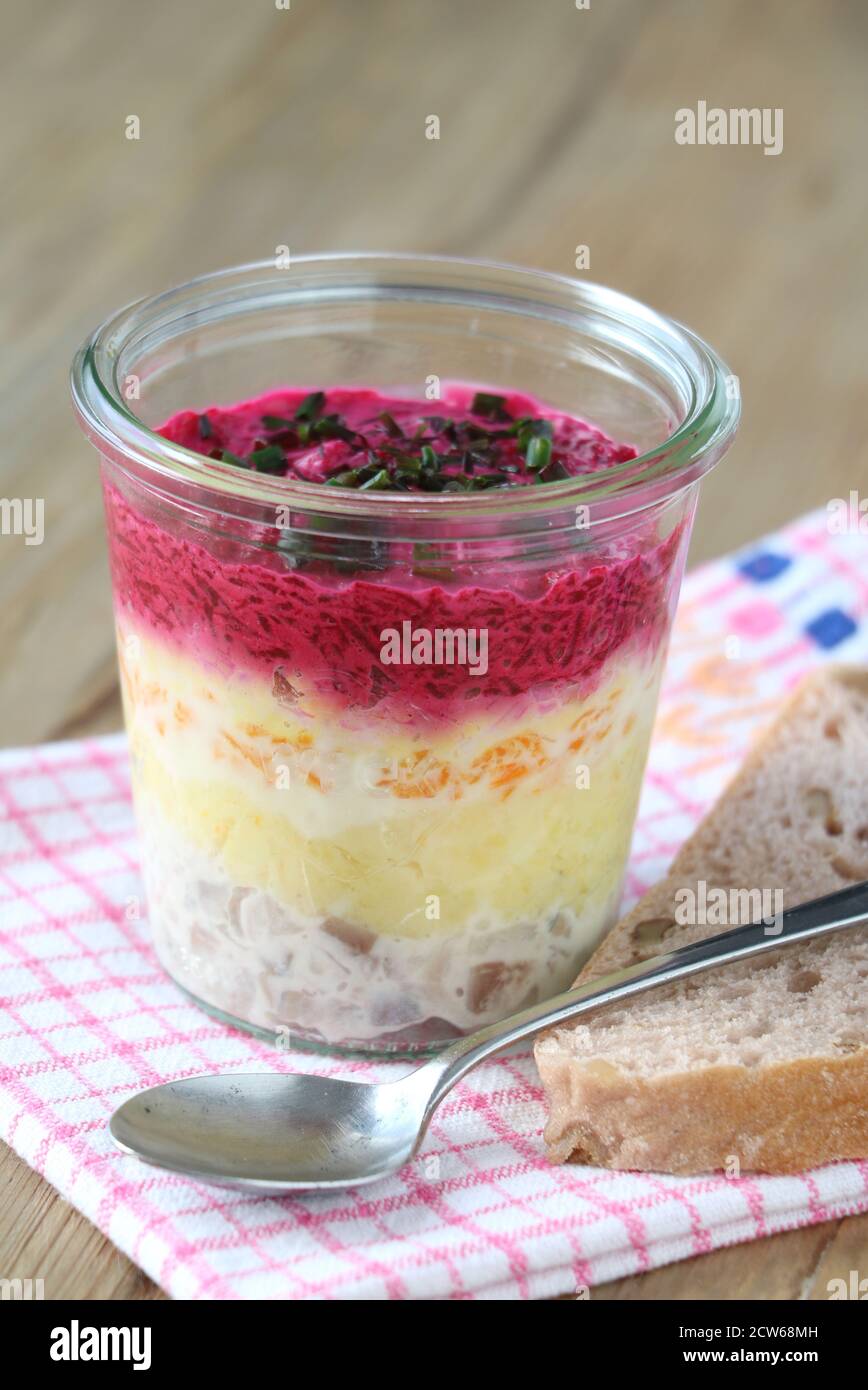 Geschichteter Salat mit Hering, Rote Bete und Kartoffeln im Glas Stockfoto