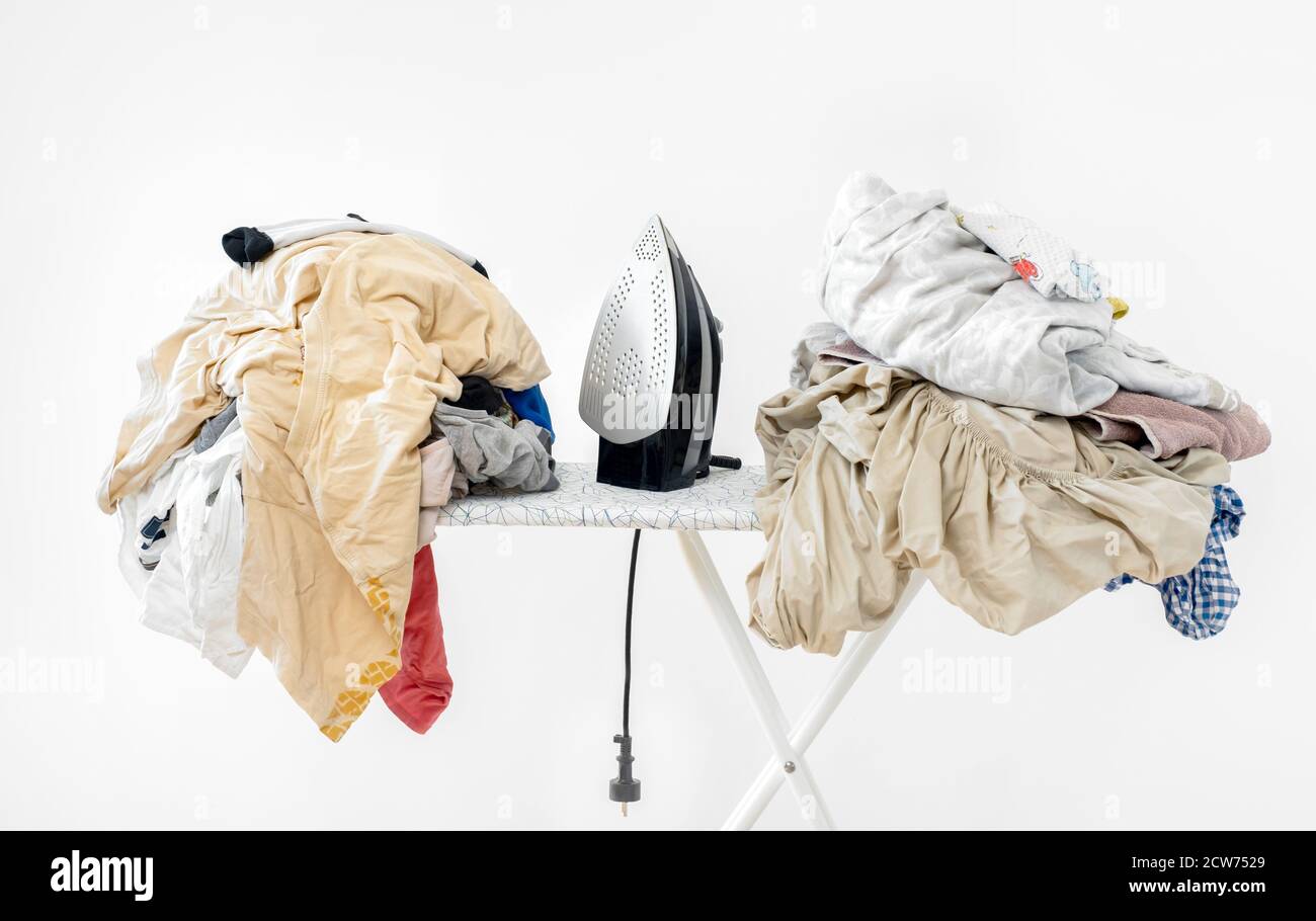 Bügeleisen auf dem Bügelbrett vor weißem Hintergrund. Hochwertiges Bügeleisen auf dem Bügelbrett vor weißem Hintergrund. Schmutzige Wäsche vor dem Bügeln nach dem Waschen Stockfoto