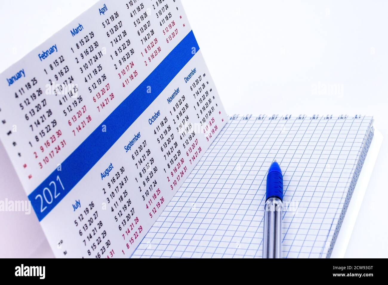 Notizblock und Kalender 2021, blauer Stift und Notizblock auf weißem Hintergrund Stockfoto