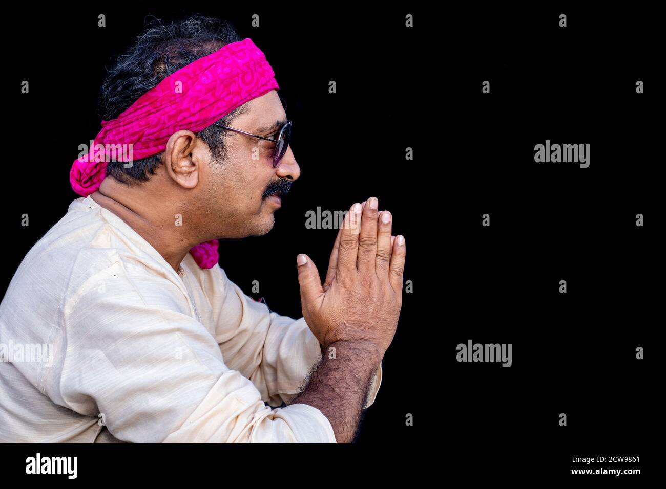 Lächelnder indischer Mann, der die Hand in namaste Geste hält, Stockfoto