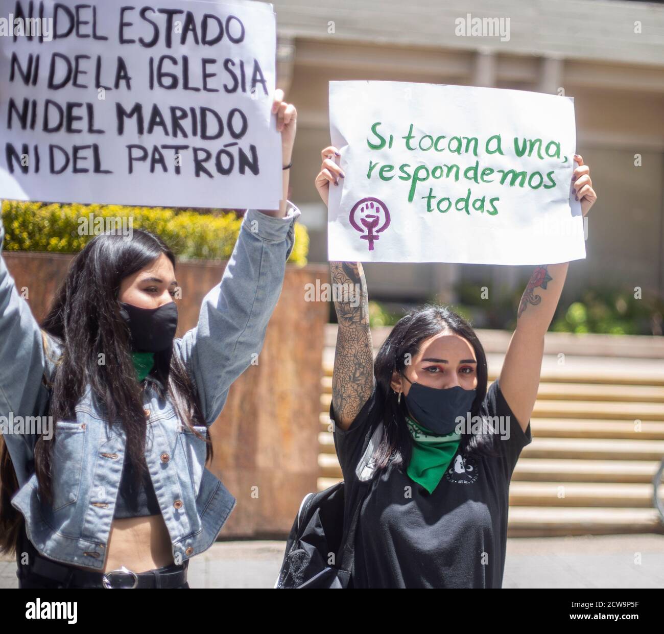 Bogota, Kolumbien. September 2020. Zwei Frauen tragen Zeichen, die sagen: "Nicht der Staat, nicht die Kirche, nicht der Ehemann, nicht der Arbeitgeber" und "wenn sie einen berühren, antworten wir alle." Im Obersten Gerichtshof von Kolumbien trafen sie sich, um für die Legalisierung von Abtreibungen im Land zu demonstrieren, ein Teil des Protestes war, mit grüner Farbe ein früheres Graffiti von nicht-Abtreibungsbefürwortern gemacht zu bedecken. Quelle: Daniel Garzon Herazo/ZUMA Wire/Alamy Live News Stockfoto