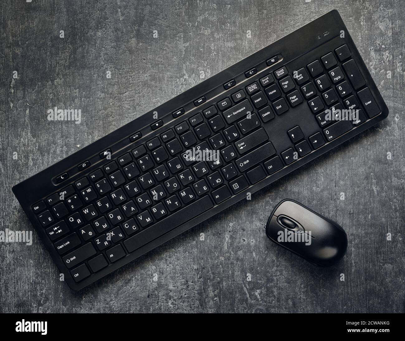 Wireless-Computer-Tastatur und Maus auf grauem Hintergrund, Nahaufnahme, sind stilisiert Stockfoto
