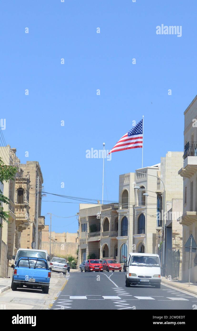 Die amerikanische Flagge, die hoch über einem Gebäude in Gozo, Malta, fliegt. Stockfoto