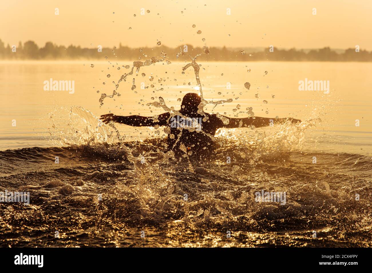 Junger Mann, der beim Schwimmen Schmetterling tief atmet Stockfoto