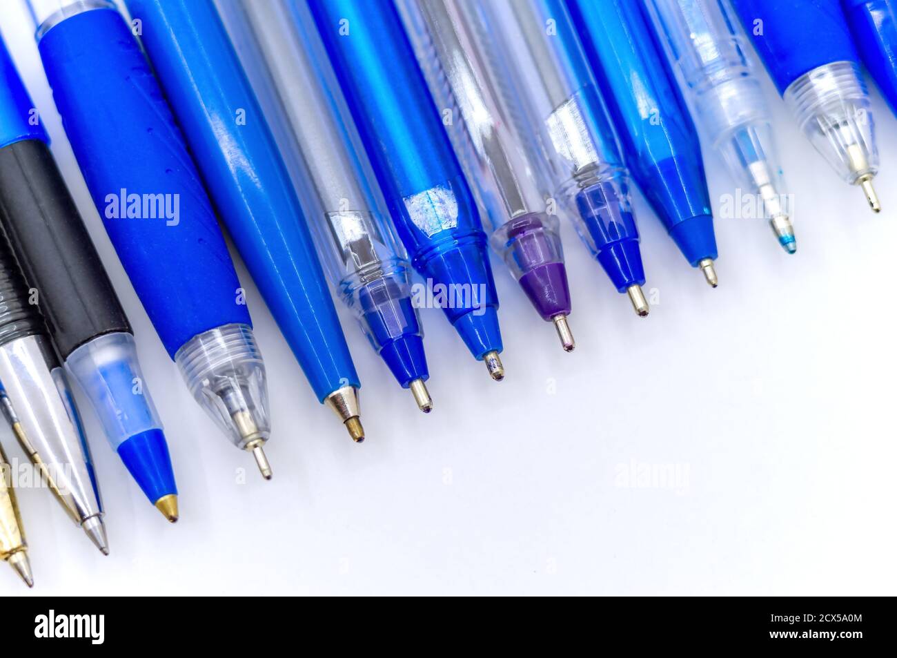 Viele blaue Kugelschreiber auf weißem Hintergrund, mehrfarbige Kugelschreiber Stockfoto