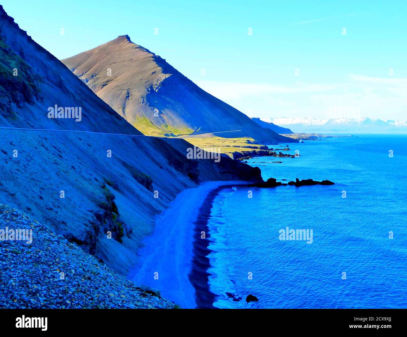 Schöne Natur von Island. Berge, Felsen, dunkler Sandstrand, kaltblaues Meer. Ruhiges Wasser. Nordsommer. Wilde Naturlandschaft. Stockfoto