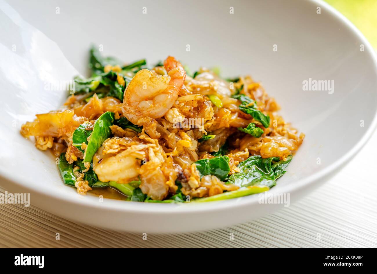 Gebratene flache Nudeln, Garnelen, Ei und Gemüse mit süßer schwarzer Sojabohnensauce, in Thailands Sprache Pad Sea EW GOOG genannt, umrühren. Nahaufnahme traditionell Stockfoto