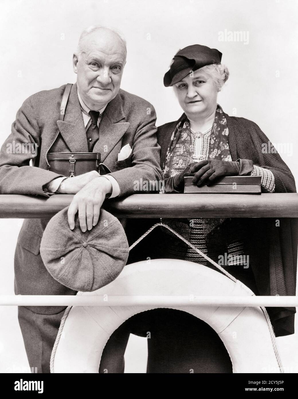 1930ER JAHRE 1940ER JAHRE GEHOBENES SENIOR PAAR MANN FRAU MANN FRAU STEHEND ZUSAMMEN AM GELÄNDER DES AUSFAHRENDEN OZEANDAMPFERS UND AUF DIE KAMERA SCHAUEND - S2841 HAR001 HARS KREUZUNG ALTE MODE RUHESTAND 1 STIL TEAMWORK WOHLHABENDE URLAUB REICHE FREUDE LIFESTYLE OCEAN FEIER ÄLTERE FRAUEN VERHEIRATET EHEGATTEN EHEMÄNNER GESUNDHEIT LUXUS KOPIEREN RAUM HALBE LÄNGE DAMEN PERSONEN MÄNNER SENIOR MANN TRANSPORT SENIOR ERWACHSENER B & W PARTNER AUGENKONTAKT ÄLTERE FRAU FREIHEIT ERFOLG ZEIT WEG TRÄUME GLÜCK ALTER LINER WELLNESS OLDSTERS KOPF UND SCHULTERN OLDSTER ABENTEUER FREIZEIT BORD TRIP GETAWAY CHOICE AUFREGUNG GELÄNDER Stockfoto