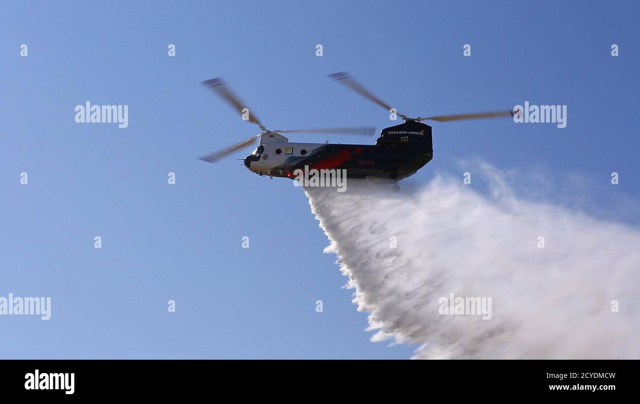 Ein CH-47 Chinook Schwerlift-Hubschrauber im Besitz und betrieben von Coulson Aviation, Inc., Tropfen Wasser auf Los Alamitos Army Airfield, September 30, 2020, für eine Flugdemonstration während einer Pressekonferenz auf Joint Forces Training Base, Los Alamitos, Kalifornien. Der Hubschrauber, der als der größte Helitanker der Welt gefeiert wird, weil er in einem einzigen Durchgang 3,000 Gallonen Wasser fallen lassen kann oder schwer entflammbar ist, ist bis Ende des Jahres auf der Basis für 24/7 Wildfire in Südkalifornien unterwegs. Der Hubschrauber kommt nach Südkalifornien durch eine Partnerschaft mit Orange County Fire Authority mit Fu Stockfoto
