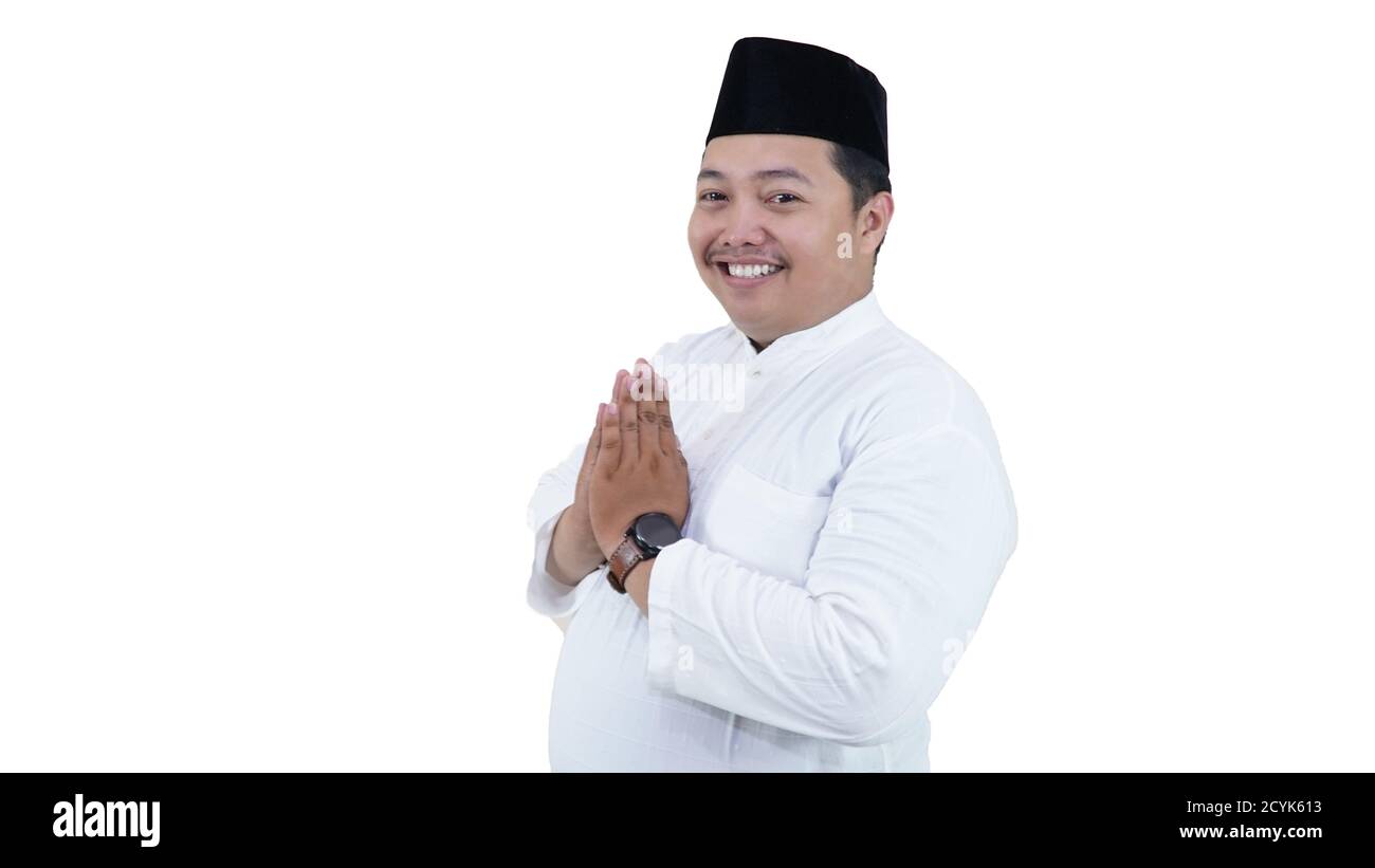 Porträt eines übergewichtigen muslimischen Mannes mit Kopfhaube oder Songkok Lächeln und Gruß an der Kamera Stockfoto