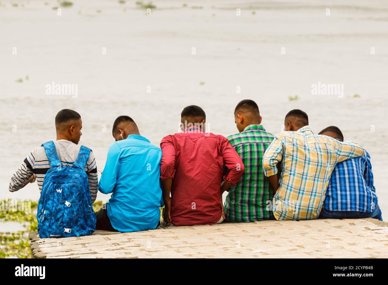 Gruppe von männlichen Freunden an der Küste von Fort Cochin am Vembanad See; Kochi (Cochin), Kerala, Indien Stockfoto