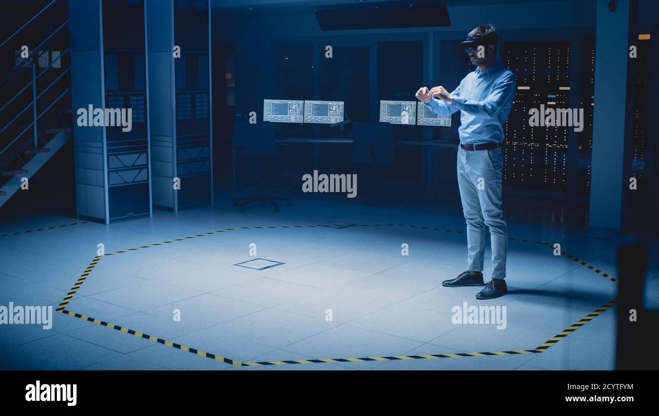 In 3D Content Creating Laboratory Engineer Wearing Professional Virtual Reality Headset funktioniert und Gesten in Augmented Reality. Industrielle Software Stockfoto