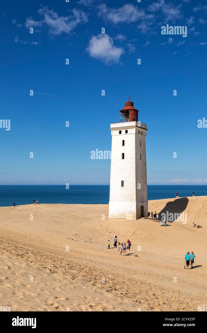 Leuchtturm auf der Düne bei Rubjerg Knude, Dänemark, an einem sonnigen Sommertag. Einige Besucher gehen herum, andere warten in der Schlange, um die historische zu erklimmen Stockfoto