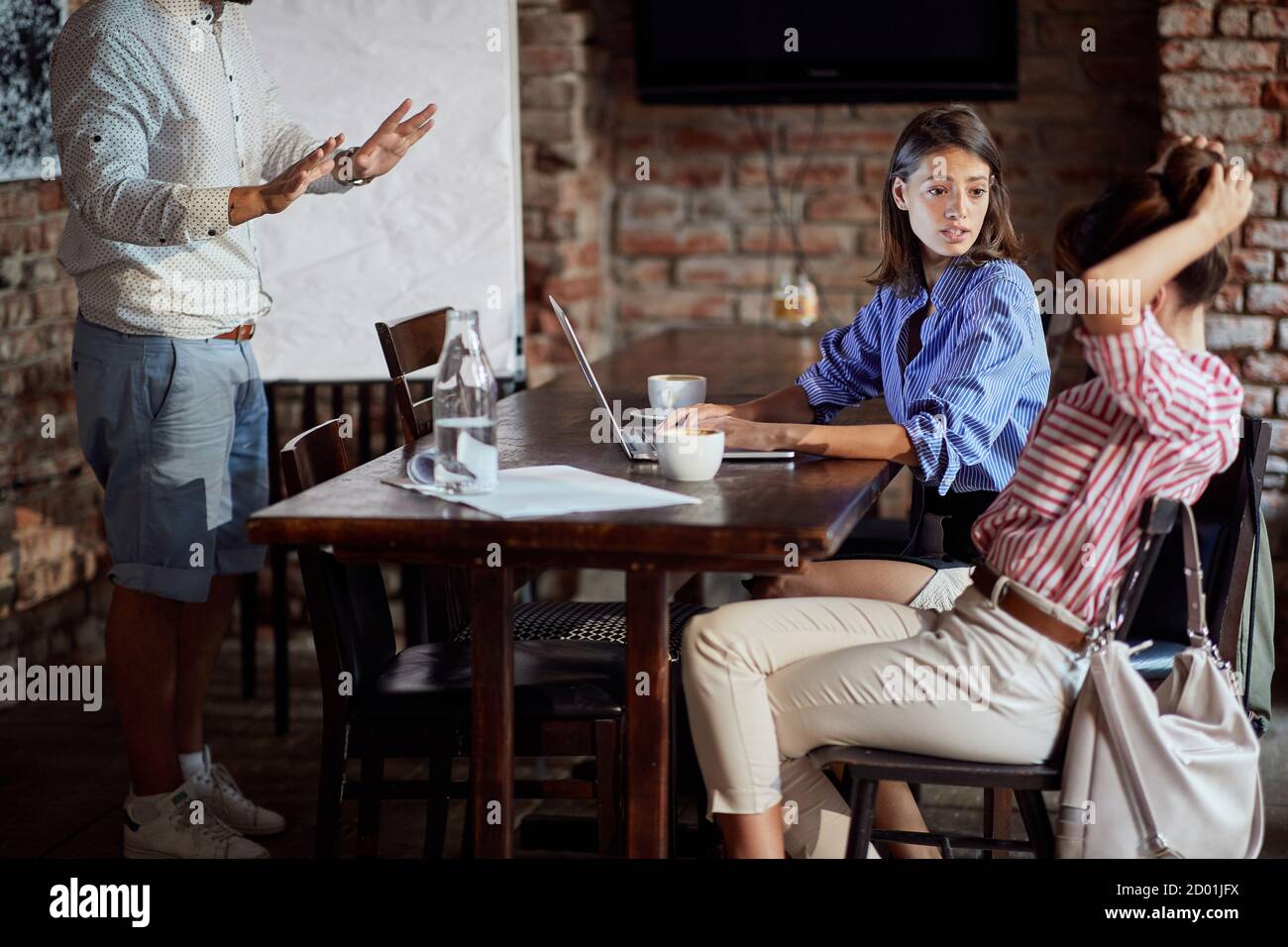 Beruhigung einer unangenehmen Situation mit einer Kellnerin bei einem Café Stockfoto