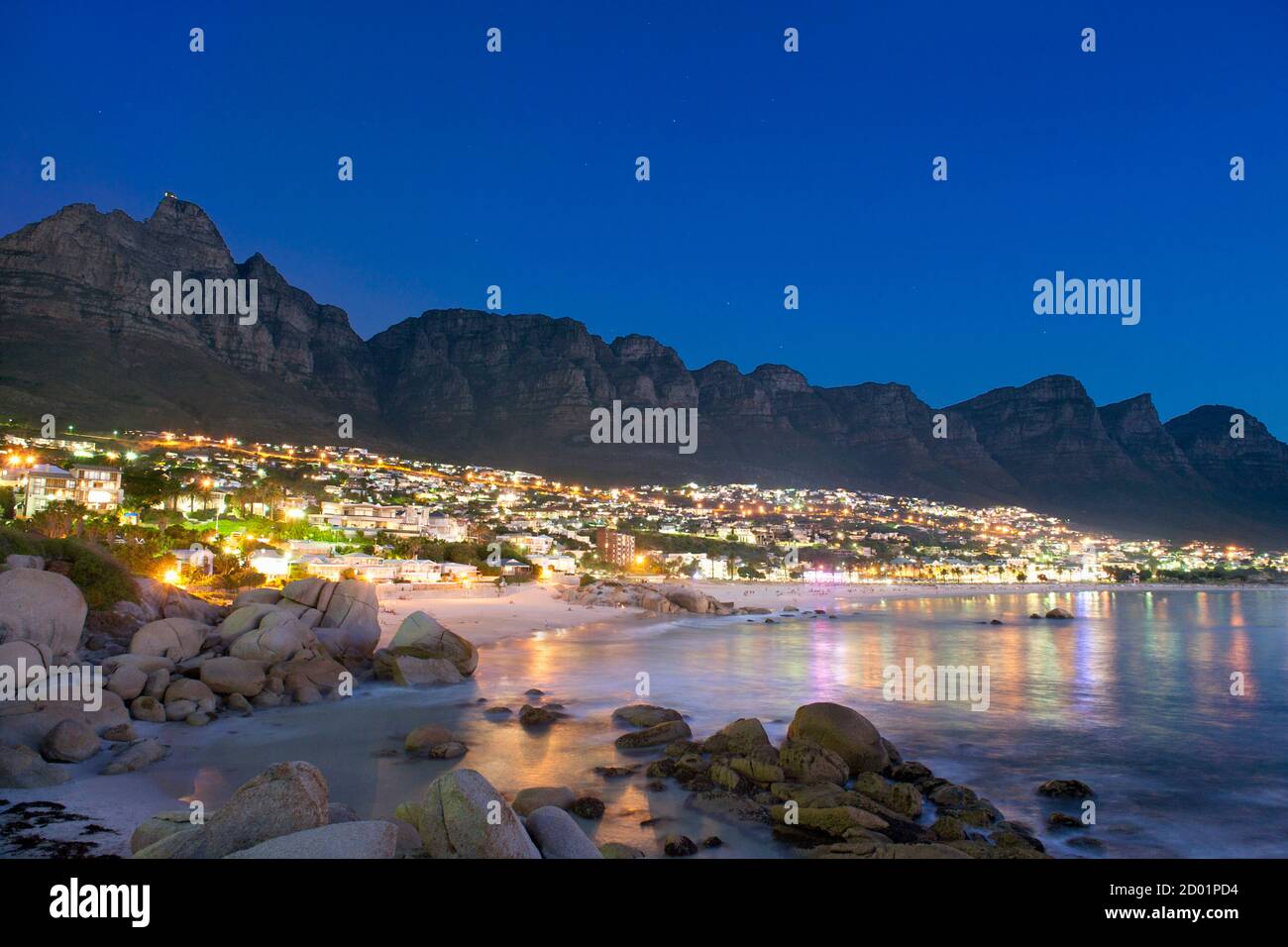 Nachtansicht von Camps Bay und den Twelve Apostles Mountains in Kapstadt. Stockfoto