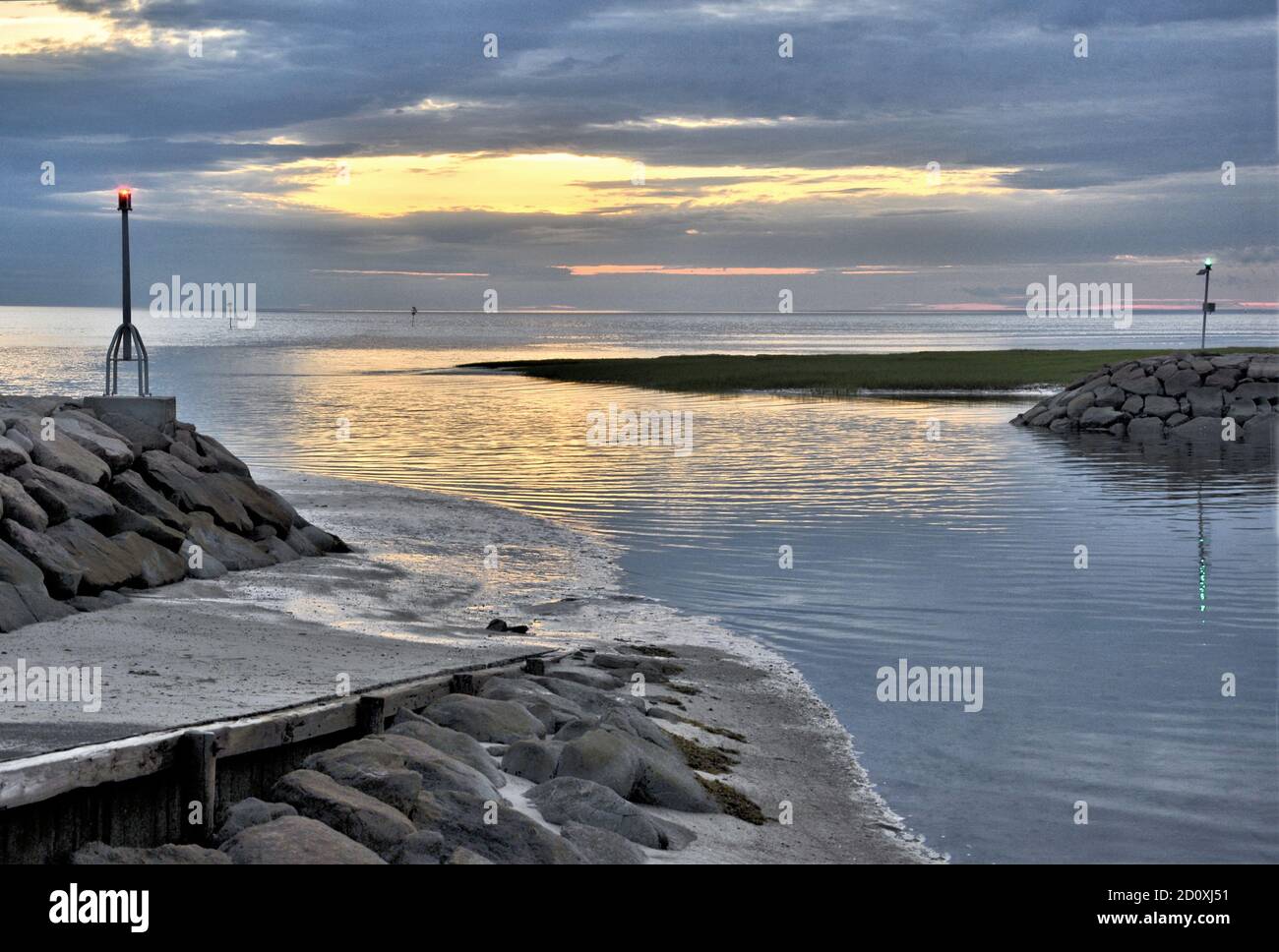 Schöner farbenfroher Sonnenuntergang am Eingang zum Rock Harbor und Bootsrampe in Cape Cod Bay, Orleans Massachusetts. Ruhige Cape Code Szene. Stockfoto