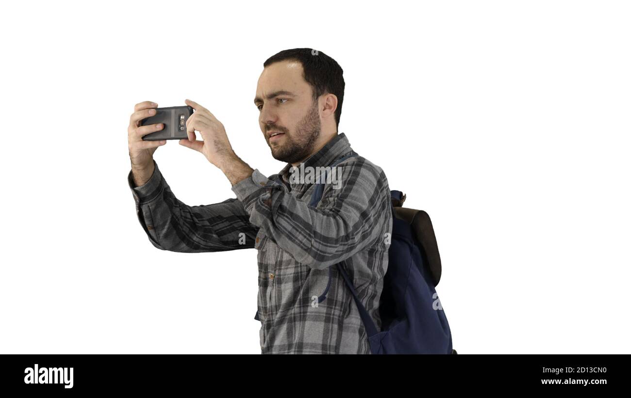 Hübscher junger Mann, der Rucksack trägt und ein Foto von nimmt Er Stockfoto