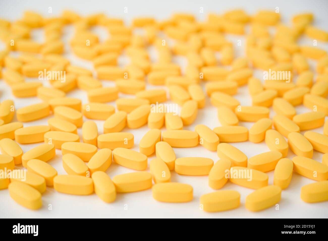 Viele gelbe Pillen Vitamintabletten auf weißem Hintergrund Stockfoto