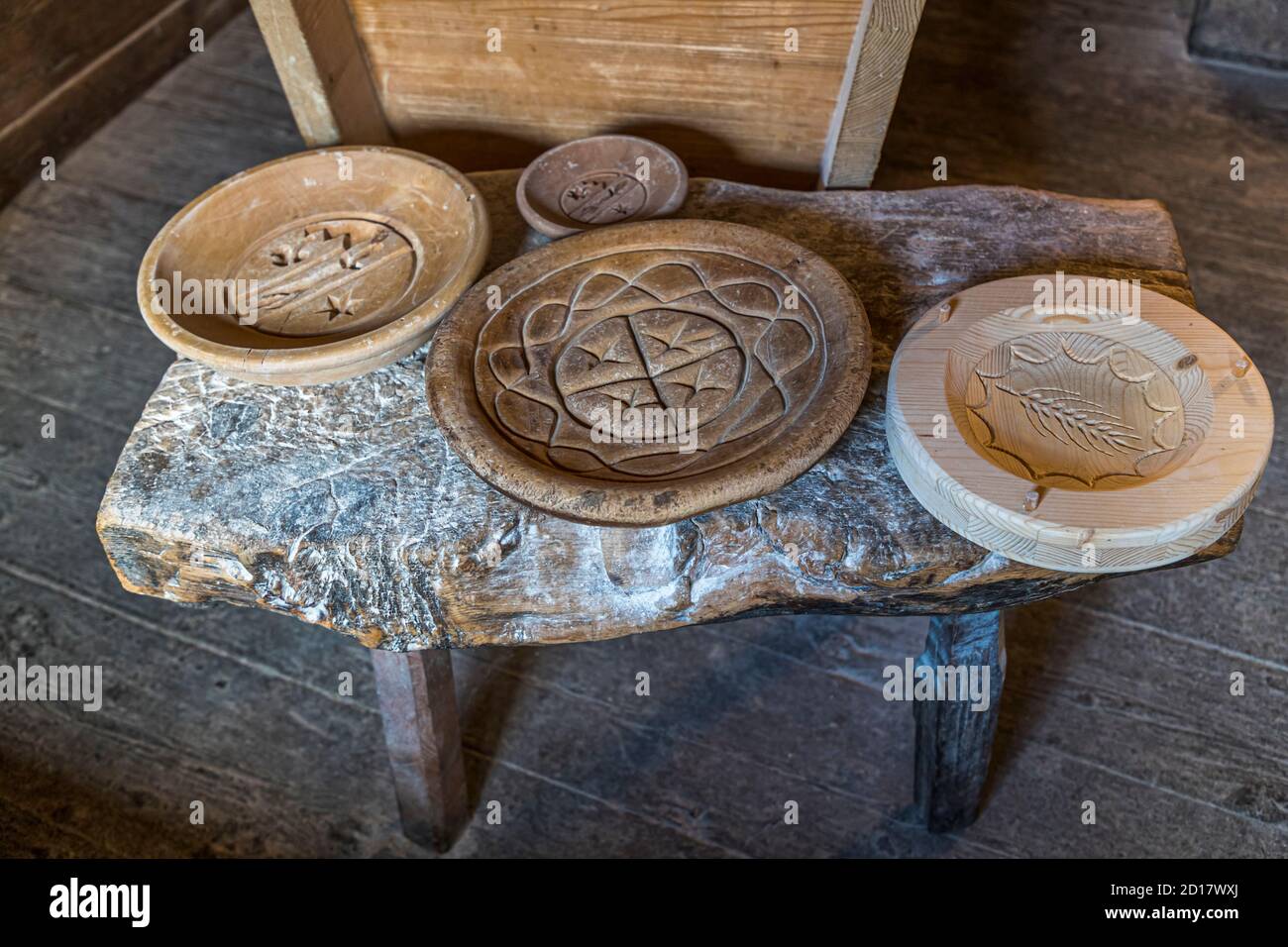 Walliser Roggenbrot-Backwerkstatt in Goppenstein-Erschmatt, Schweiz. Es gibt Holzstempel mit dem Wappen von Erschmatt. Mit Schwert und dem Schutzpatron St. Michael, einem Stern, den Bergen und einem Kleeblatt Stockfoto