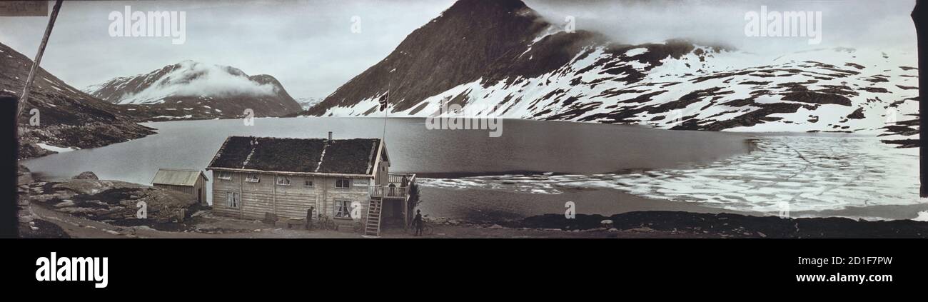 Koloriertes Panorama einer "Fast Skyds Station", einem Rastplatz für Besucher und Pferde, entlang der Ufer des Djupvatnet, auch bekannt als Djupvand, Norwegen, 1909. (Foto von Burton Holmes) Stockfoto