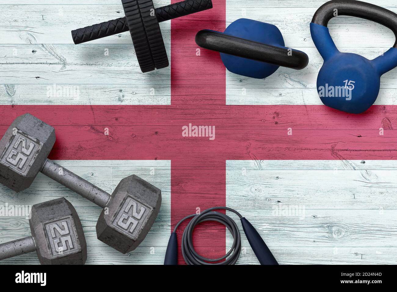 England Sportverein Konzept. Draufsicht auf schwere Hantelscheiben mit Eisenstange im nationalen Hintergrund. Stockfoto