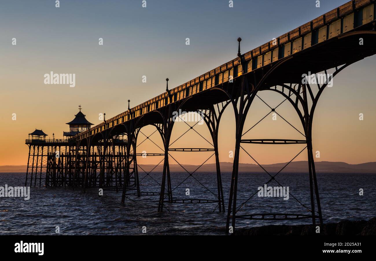 Der viktorianische Pier in Clevedon, beleuchtet von der untergehenden Sonne Stockfoto