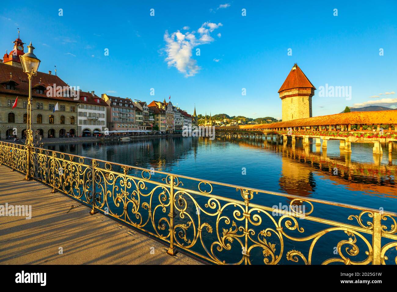 Stadtbild von Luzern am Vierwaldstättersee, Schweiz bei Sonnenuntergang. Historische überdachte hölzerne Fußgängerbrücke, Kapellebrücke mit Wasserturm reflektieren auf Reuss Stockfoto