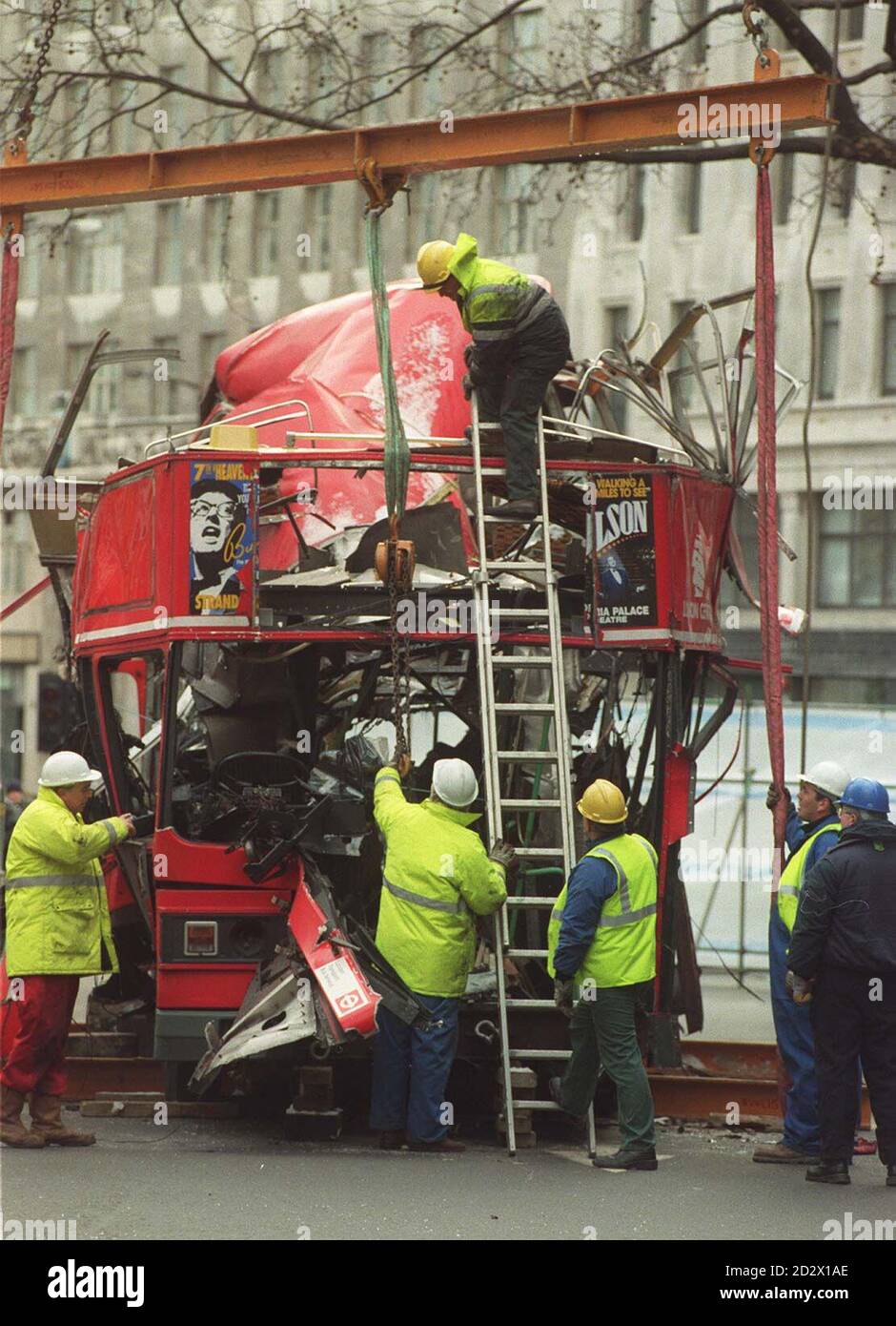 Arbeiter bereiten sich darauf vor, das Wrack des bombardierten Doppeldeckerbusses am Aldwych in London zu heben. Stockfoto