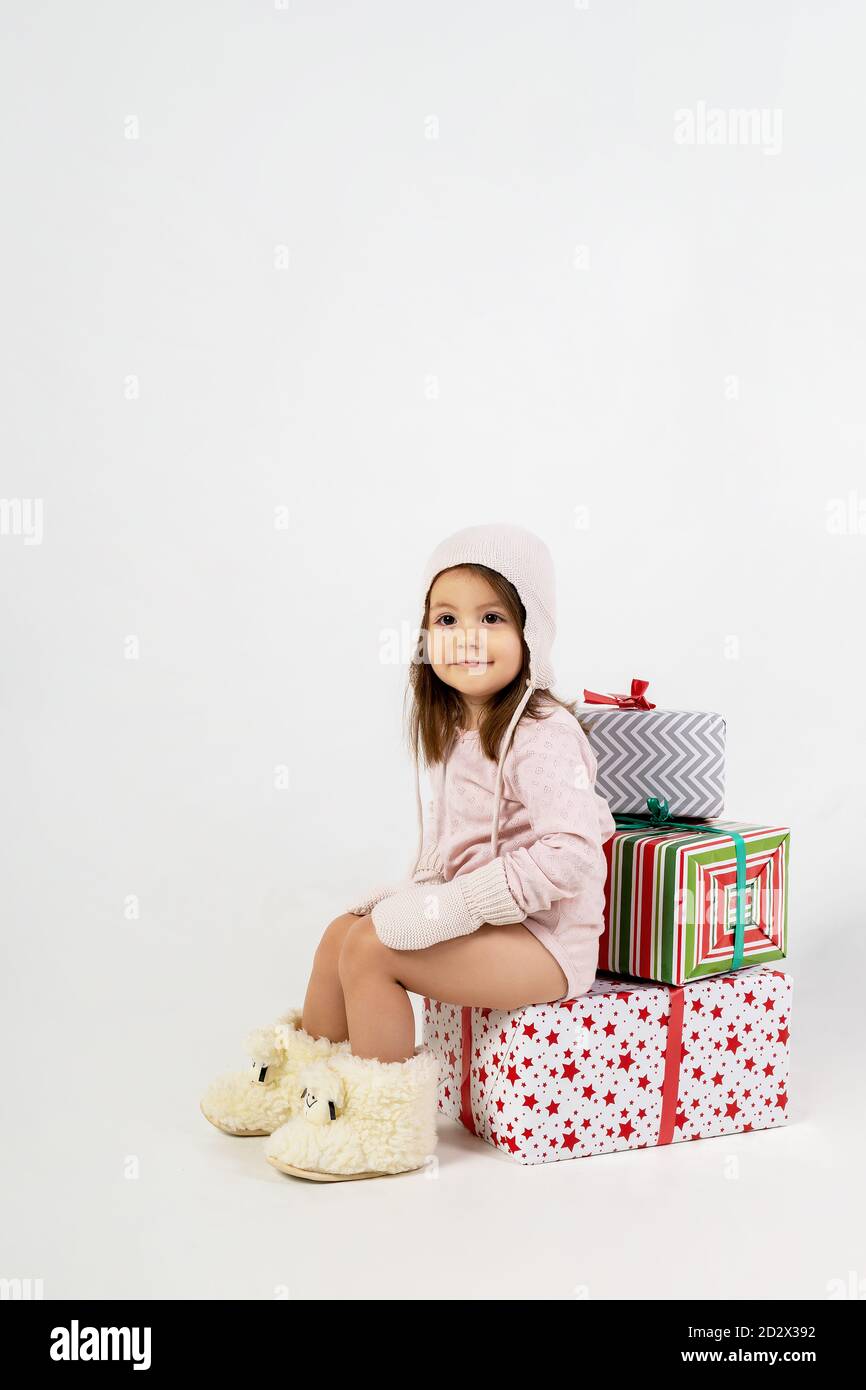 Neujahr Bild: Kleines Mädchen in Stiefeln auf Geschenken sitzen Stockfoto