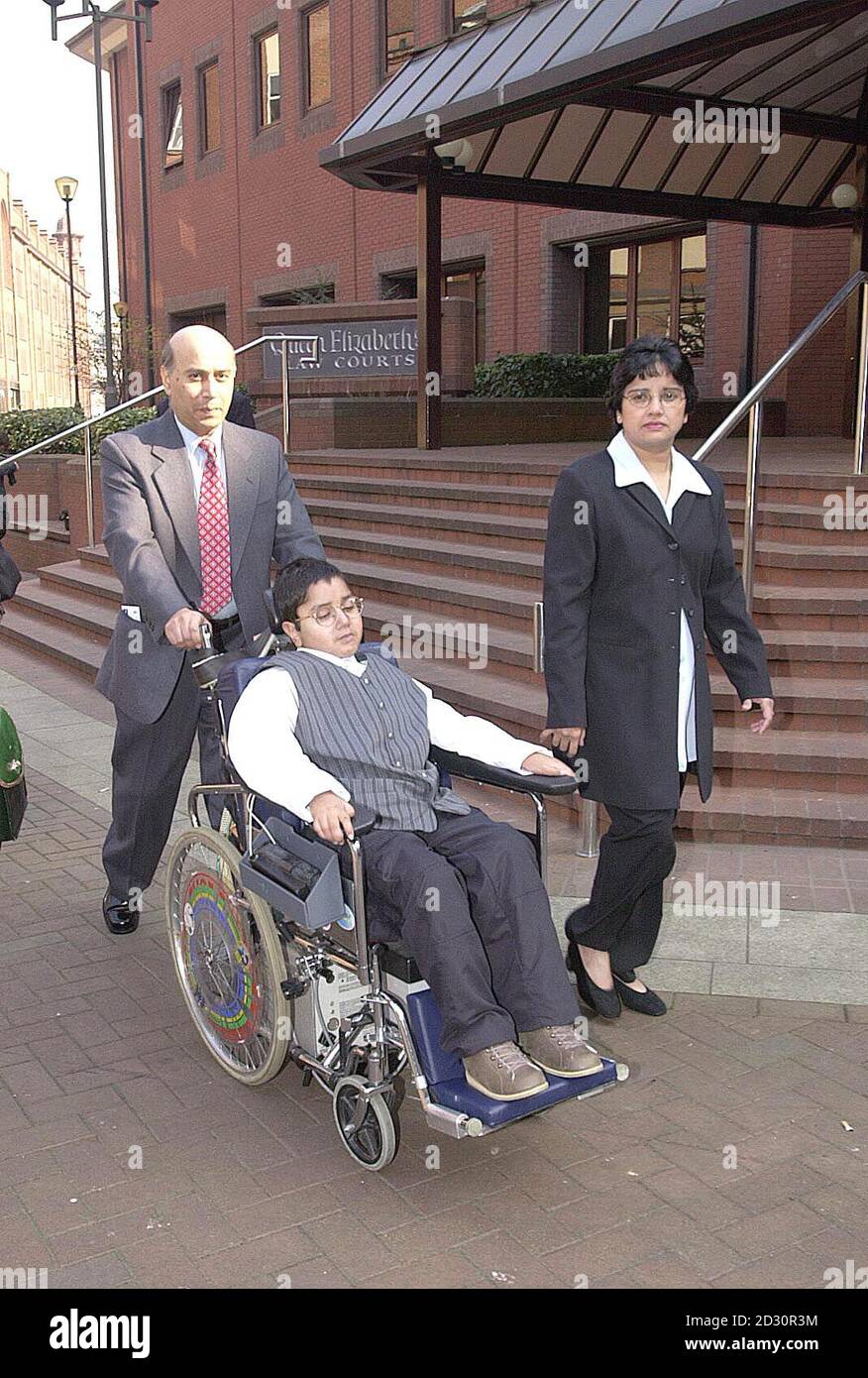 Faisal Luhar im Alter von 10 Jahren mit seinen Eltern Yusuf und Maimuna kommen am High Court in Birmingham, wo sie erfahren, wie hoch die Entschädigung für einen Unfall, den er im Alter von drei Jahren erlitten. Stockfoto