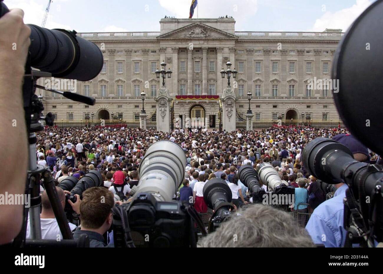 Vor dem Buckingham Palace in London versammeln sich Menschenmassen, die darauf warten, dass die Queen Mother während ihrer Feierlichkeiten zum 100. Geburtstag auf dem Balkon erscheint. Stockfoto