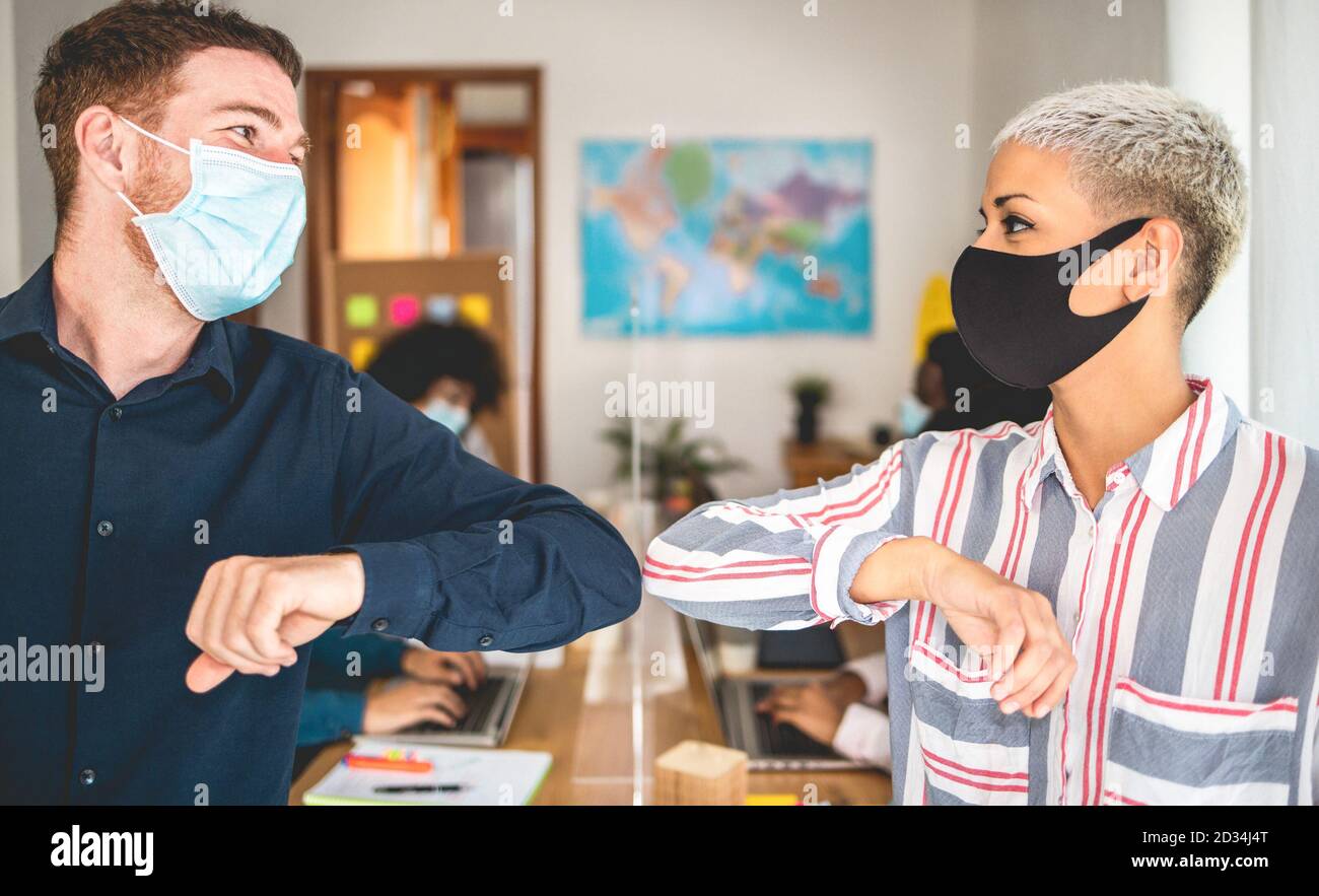 Junge Mitarbeiter stoßen ihre Ellbogen, anstatt mit einem Handschlag zu grüßen - vermeiden Sie die Ausbreitung von Coronavirus, sozialer Distanz und Freundschaftskonzept - FOC Stockfoto