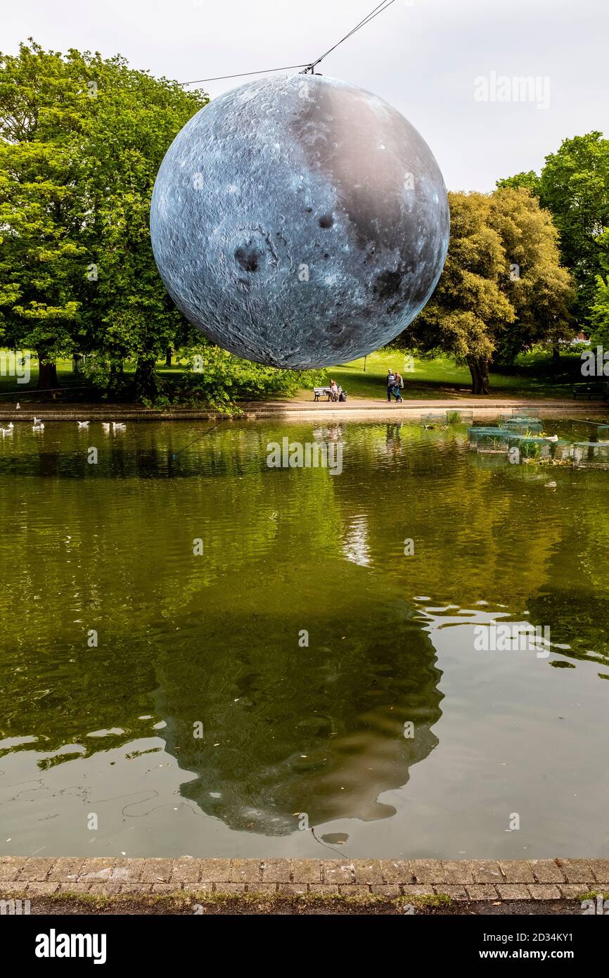 Ein Riesenmodell des Mondes (Museum of the Moon von Luke Jerram) erhebt sich während des Brighton Festival, Brighton, Sussex, Großbritannien, über dem Queen's Park Pond Stockfoto