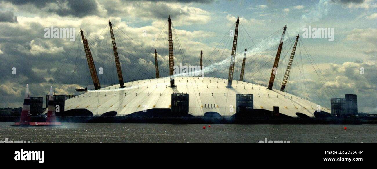 Red Bull Air Race Piloten fahren am O2 Millennium Dome mit 400 km/h entlang der Themse in den Docklands in London vorbei. Stockfoto