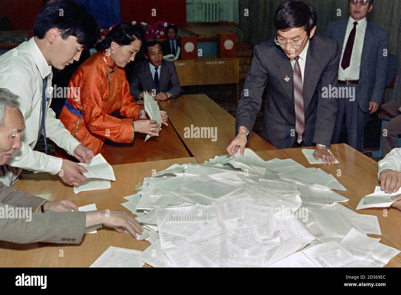 Mongolische Wahlbeamte beginnen, nach den ersten demokratischen Mehrparteienwahlen in der ehemaligen kommunistischen Nation am 30. Juli 1990 in Ulaanbaatar, Mongolei, die Stimmen für die Zählung zu sortieren. Die Wahlen sind das Ergebnis einer friedlichen demokratischen Revolution, die die autoritäre kommunistische Regierung gestürzt hat. Stockfoto