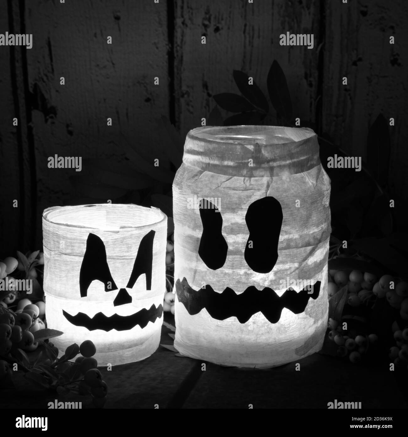 Lustige künstliche halloween weiße Geisterdekoration aus Papier und Glas mit brennender Kerze im Inneren Stockfoto