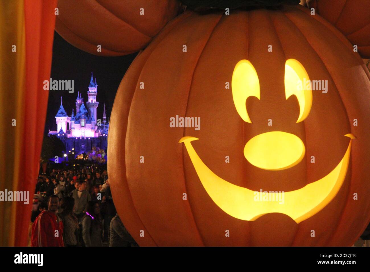 Mickey Mouse geformter Kürbis im Disneyland California mit Dornröschen Schloss dahinter Stockfoto