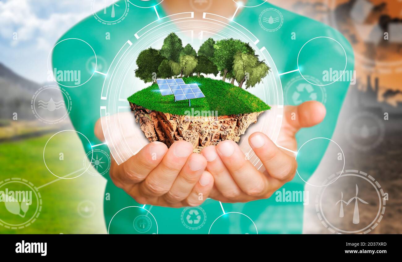 Hände des Mannes, der eine Insel mit grünem Gras, Bäumen und Sonnenkollektoren im Konzept des Umweltschutzes hält. Hintergrund als Konzept der Energieeffizienz Stockfoto