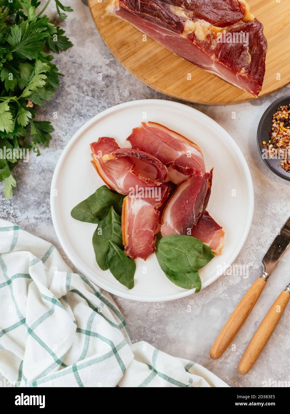 Pastrami in Scheiben geschnitten auf einem Teller mit Kräutern Stockfoto