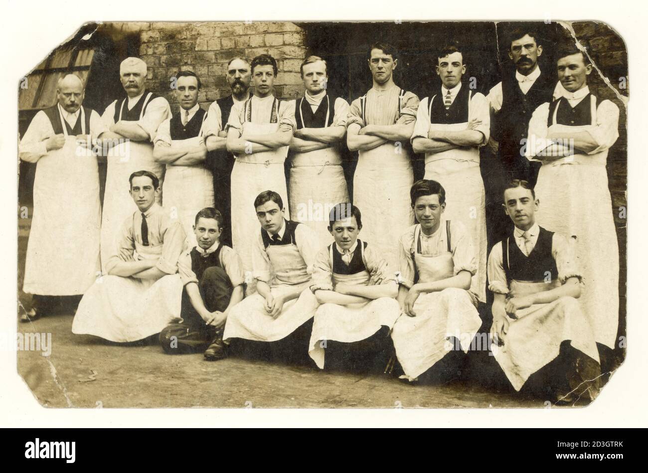 Original-Postkarte aus der Zeit vor dem 1. Weltkrieg der 1900er Jahre von Metzgern oder Bäckern, vielen jungen Lehrlingen, Studio von G. Triggle Fotograf, Heanor, Derbyshire, England, Großbritannien, um 1913 Stockfoto