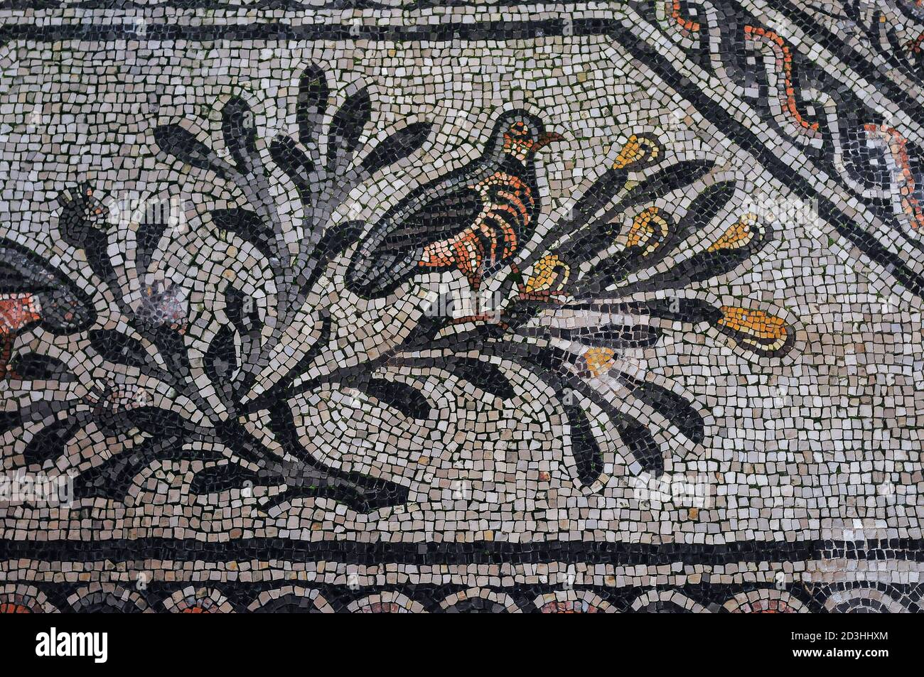 Ein Vogel auf einem Ast, der die Seligen im Paradies symbolisiert. Details des riesigen 300s n. Chr. Mosaiks in der Basilica di Santa Maria Assunta in Aquileia, Friaul-Julisch Venetien, Italien. Geschaffen von frühen christlichen Künstlern, als sich das Christentum über das Römische Reich verbreitete. Stockfoto