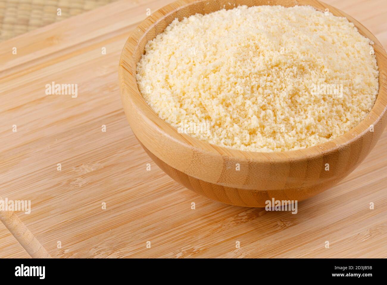 Nahaufnahme von Holzschüsseln mit geriebenem Parmesan-Käse Ein Holzhintergrund Stockfoto