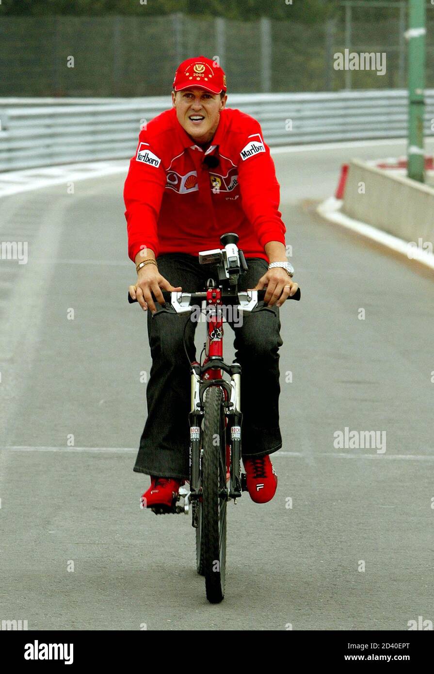 Der deutsche Ferrari-Pilot und Weltmeister Michael Schumacher fährt mit dem  Fahrrad, um die Strecke vor dem belgischen Formel 1 Grand Prix in Spa  Francorchamps am 29. August 2002 zu inspizieren. Das Rennen