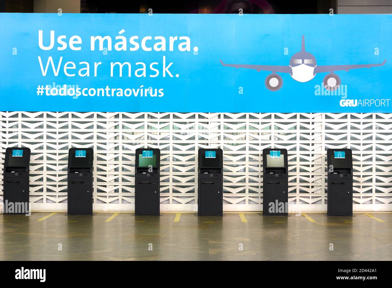Der Check-in am Guarulhos Airport Terminal 2 ist während der Coronavirus-Pandemie leer und erinnert die Passagiere daran, eine Maske zu tragen. Vorsichtsmaßnahmen am Flughafen aufgrund von Covid 19. Stockfoto
