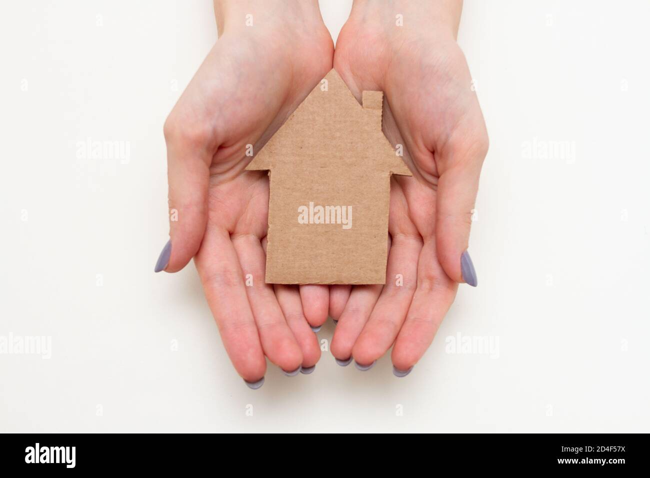 Papierhaus in weiblichen Händen. Familienhauskonzept Stockfoto