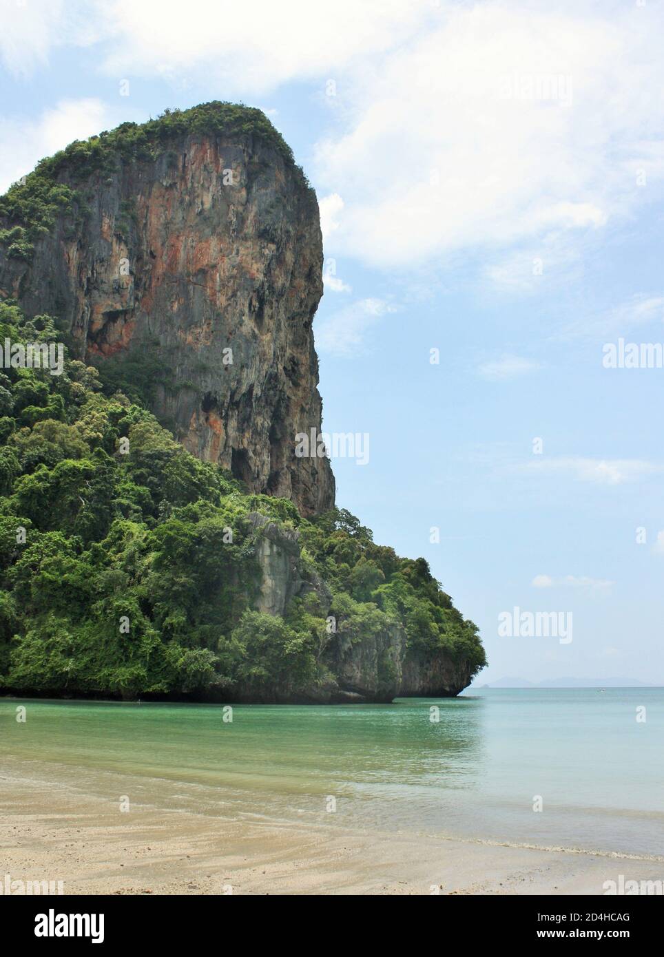 Steile Kalksteinklippen, die hoch über dem Wasser am Railay West Beach in der Provinz Krabi, Thailand, ragen Stockfoto