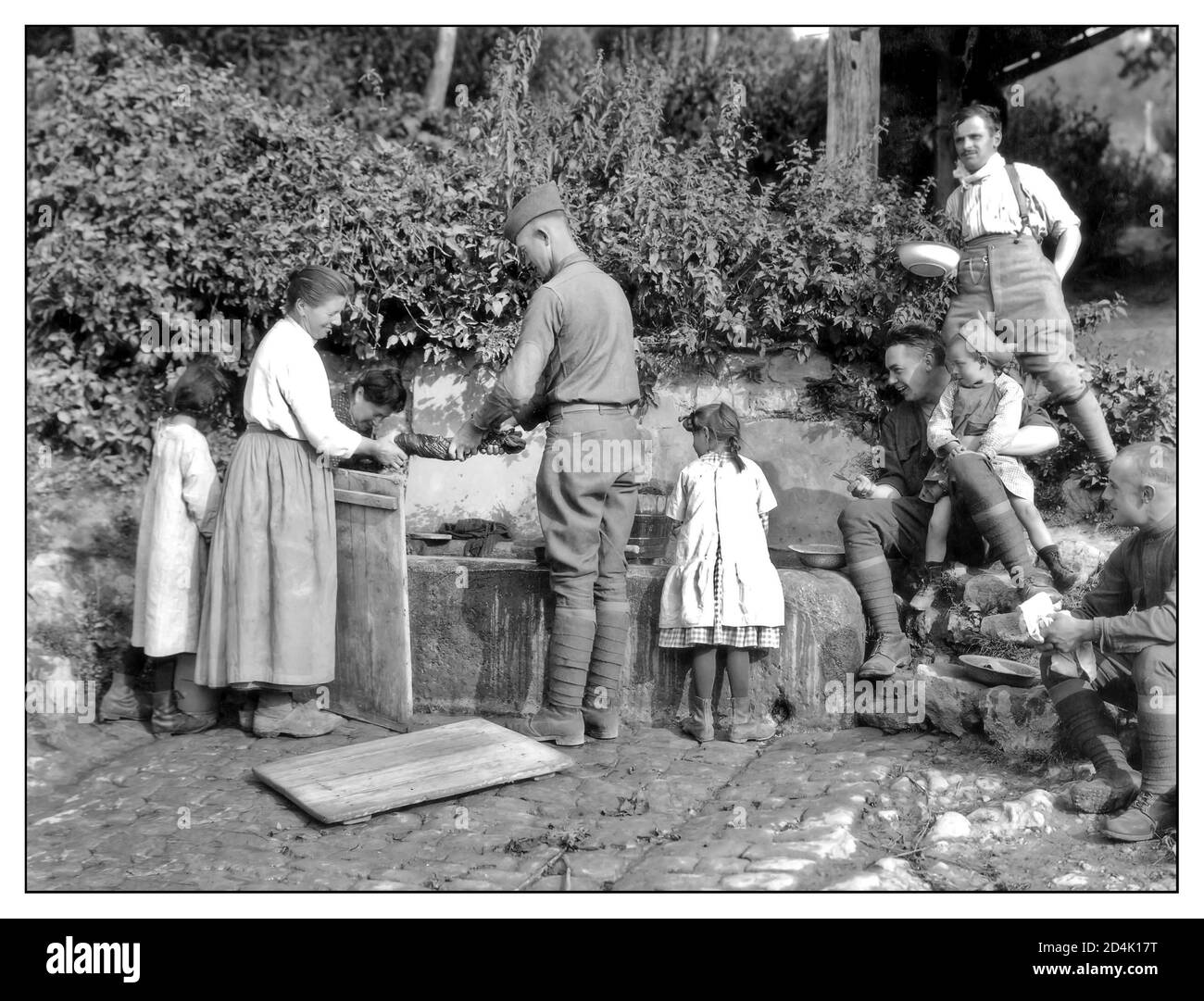 Propagandafoto des 1. Weltkriegs amerikanische Soldaten waschen ihre Kleidung mit Hilfe von französischen Dorfbewohnern in Lucy France 16-Aug-1918. Erster Weltkrieg Frankreich Stockfoto