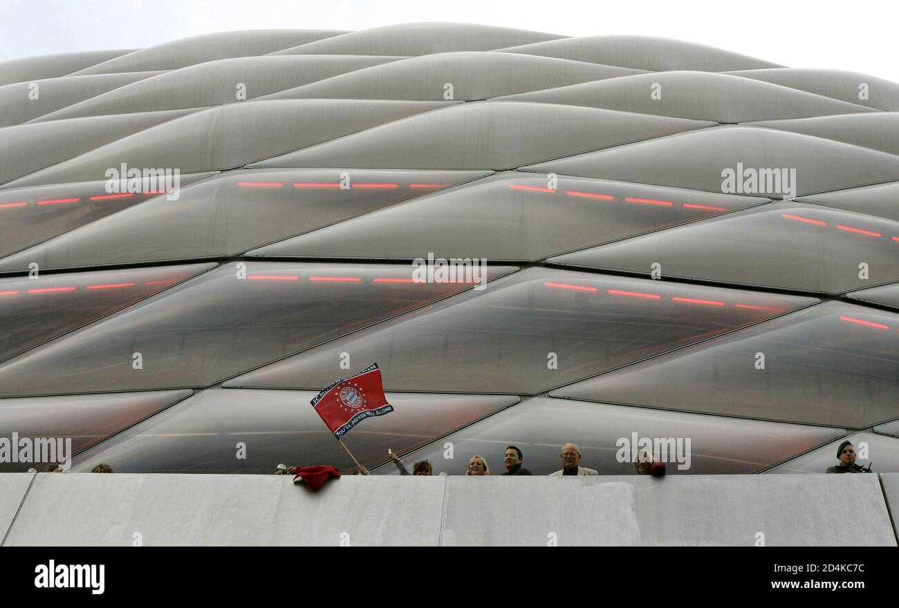 Ein Anhänger des Fußballvereins FC Bayern München winkt eine Flagge vor die  Eröffnungsfeierlichkeiten für die Allianz Arena in München. Ein Anhänger  der Münchner Fußball Erstligisten FC Bayern München "Wellenlinien" der FC  Bayern