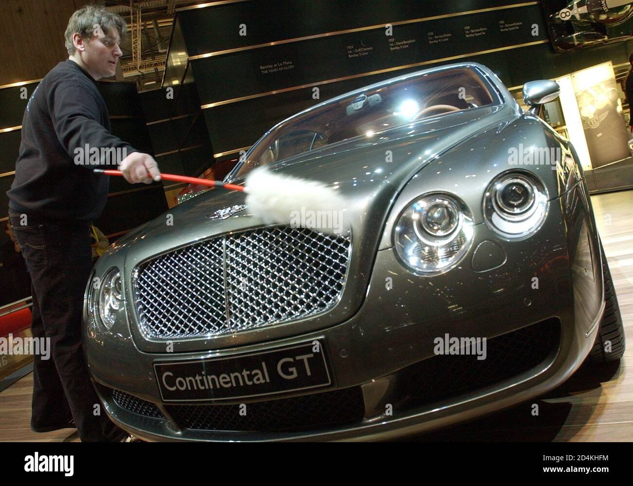 Ein Mitarbeiter wischt die Motorhaube des neuen Bentley Continental GT  während seiner ersten Weltpräsentation auf der Genfer Automobilmesse am 4.  März 2003 in Genf, Schweiz. Der Bentley Continental GT wird mit einem