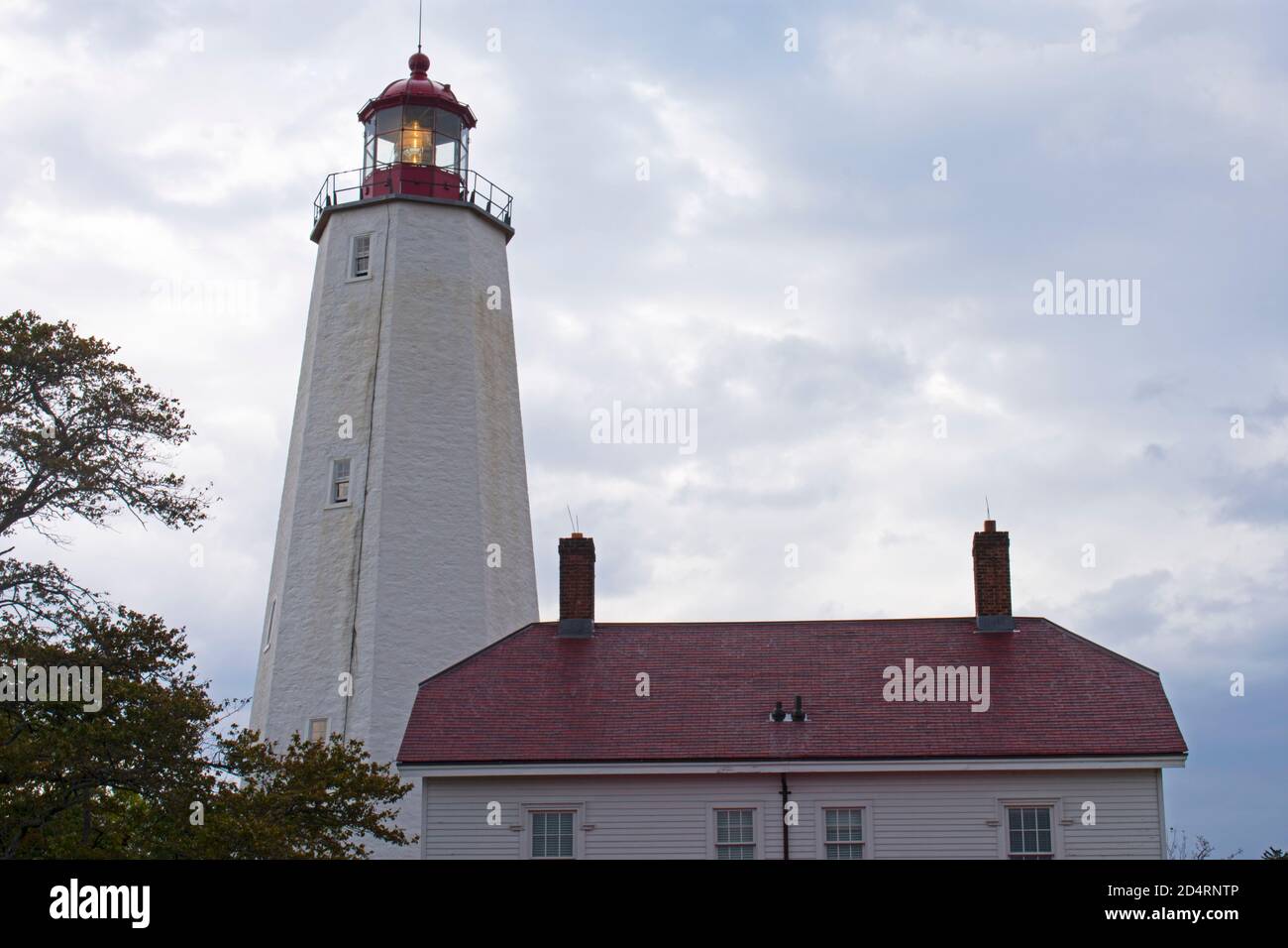 Leuchtturm in Sandy Hook, New Jersey, in der Dämmerung an einem bewölkten Tag mit seinem Licht schwach -31 scheint Stockfoto